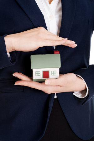 Close up on house modal in business woman's hands on belly.の写真素材