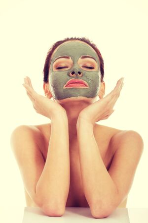 Beautifu toplessl woman with facial mask having her eyes closed.の写真素材