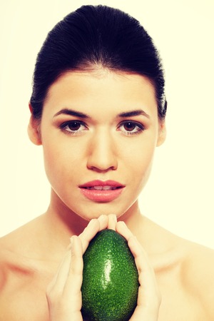 Beautiful woman's face with avocado.の写真素材