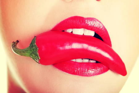 Beautiful woman with hot paprika.の写真素材