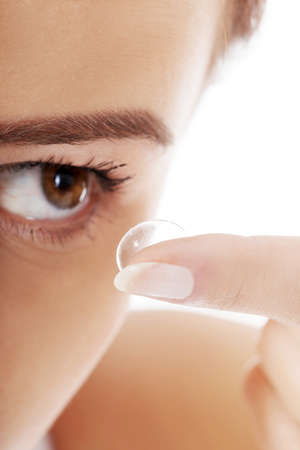 Close up of a woman putting contact lens in her eyeの写真素材