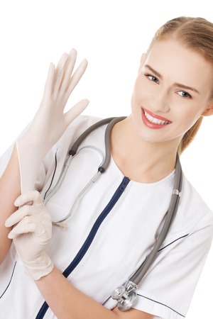 Beautiful caucasian doctor or nurse putting white sterile glove  Isolated on white の写真素材