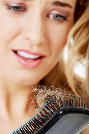 Stressed young woman loosing hairの写真素材