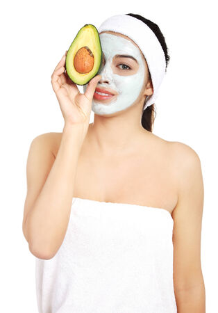 Beautiful spa woman in facial mask and avocado.の写真素材