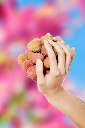 Beautiful nude woman holding litchiの写真素材