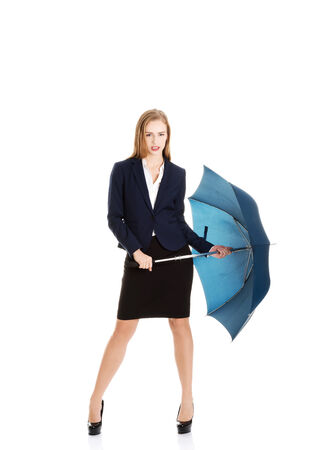 Blonde businesswoman holding an umbrellaの写真素材