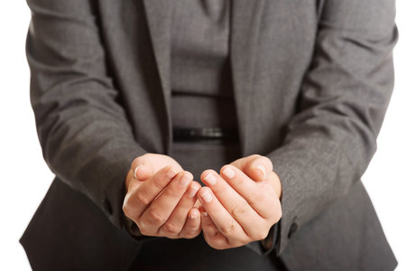 Woman with cupped hands for a productの写真素材