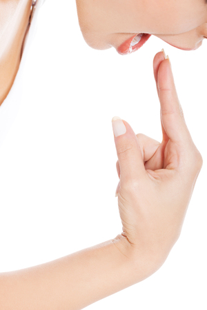 Woman provoke vomiting by putting finger to mouthの写真素材