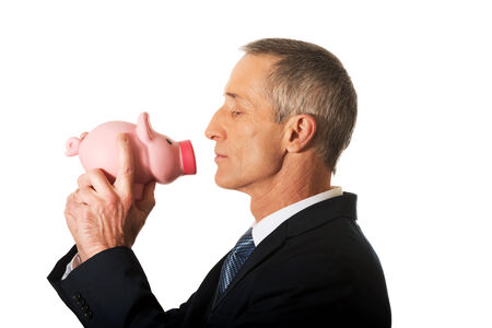 Side view businessman with piggybank.の写真素材