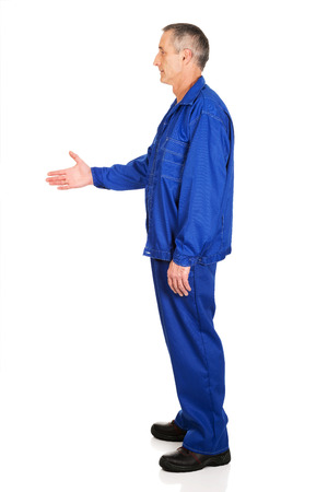 Full length side view of repairman ready to handshake.の写真素材