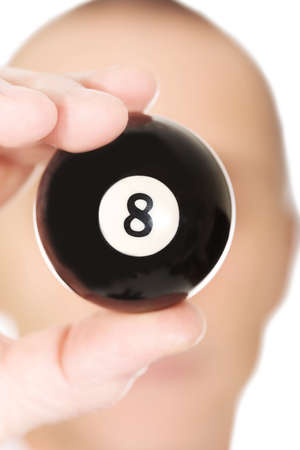 Businessman holding billiard eight ball in his hand.の写真素材