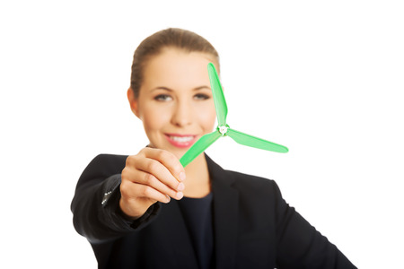 Beautiful caucasian business woman with green propeller. Isolated on white.の写真素材