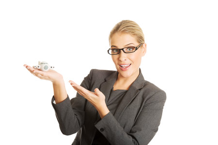 Beautiful businesswoman with plane toy in handの写真素材