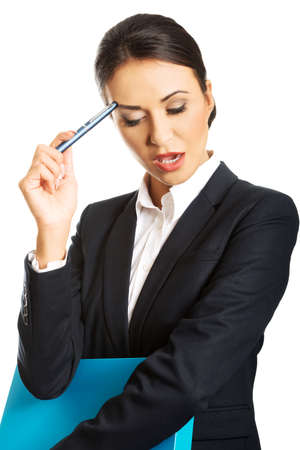 Thoughtful businesswoman holding a pen.の写真素材