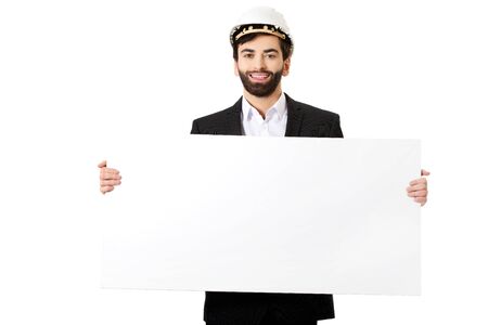 Smiling businessman with hard hat holding empty banner.の写真素材