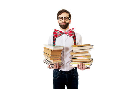 Handsome man wearing suspenders holding stack of books.の写真素材