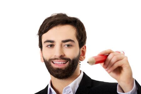 Handsome businessman writing with big red pencil.の写真素材