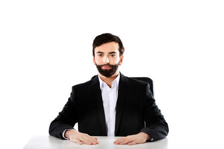 Smiling businessman sitting at the desk.の写真素材