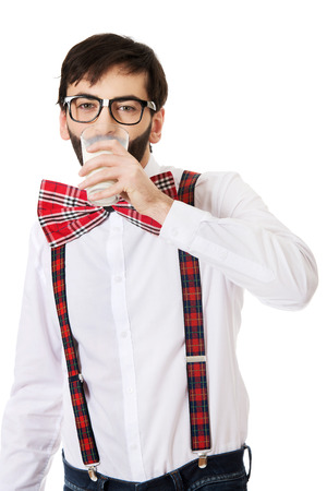 Funny man wearing suspenders drinking milk.の写真素材