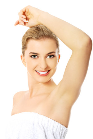 Beautiful happy spa woman showing her shaved armpit.の写真素材
