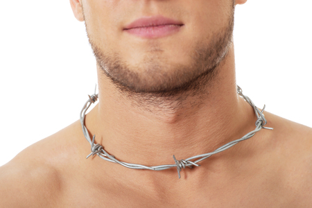 Handsome man with spikes around neck. Throat pain concept.の写真素材