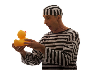 Mature sad man prisoner criminal with rubber duck.の写真素材