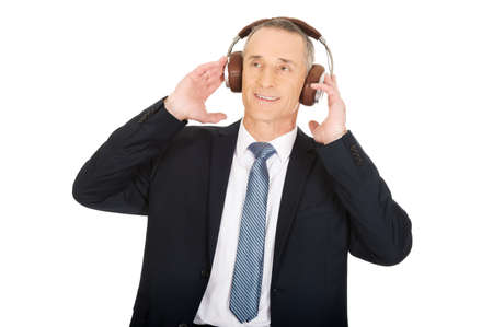 Mature businessman with big headphones.の写真素材