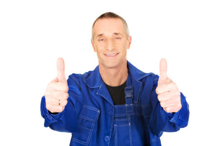 Mature repairman showing thumbs up.の写真素材