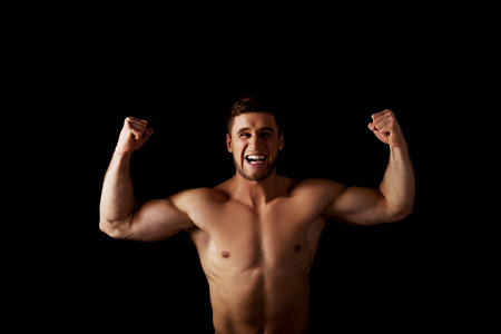 Handsome angry muscular man making fists.の写真素材