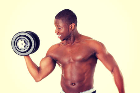 Handsome african man working out with weights.の写真素材
