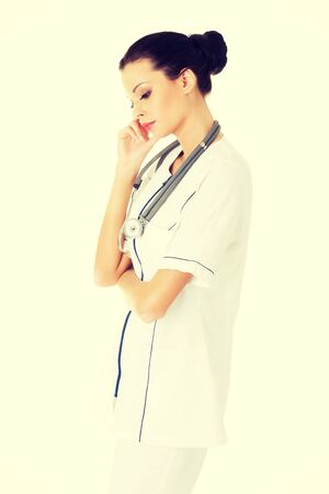 Beautiful pensive young woman doctor.の写真素材