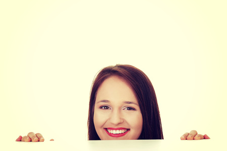Young happy casual woman with blank board.の写真素材