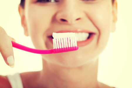 Healthy woman brushing her teeth.の写真素材