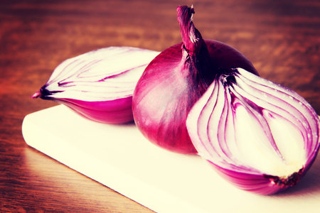 Red onion on a wooden table.の写真素材