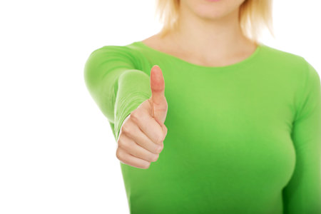 Happy young woman showing thumbs up.の写真素材