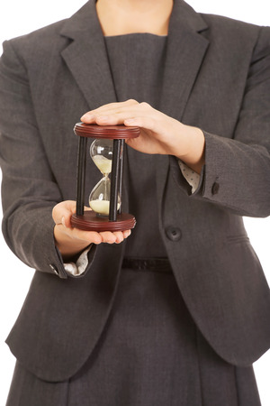 Business woman hand holding hourglass.の写真素材