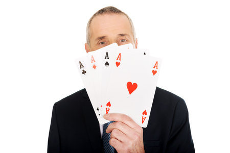 Smart mature man with four aces.