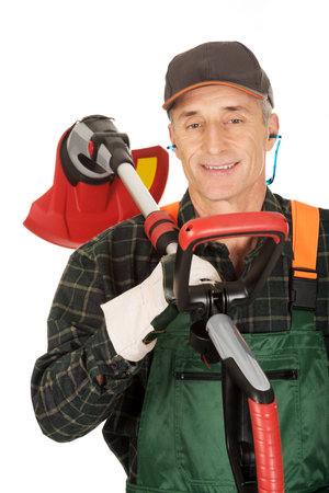 Experienced gardener with trimmer and ear protectorsの写真素材
