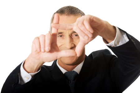 Portrait of businessman gesturing frame.の写真素材