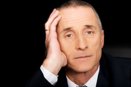 Portrait of serious businessman sitting at desk.の写真素材