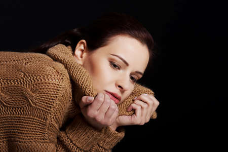 Portrait of a woman wrapped in warm scarf.の写真素材