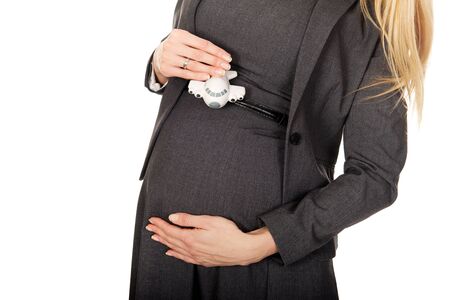 Pregnant businesswoman holding small airplane.の写真素材