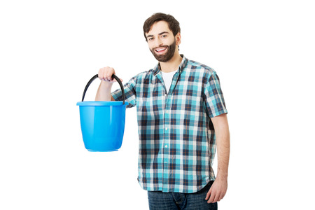 Young handsome man holding plastic blue bucket.の写真素材