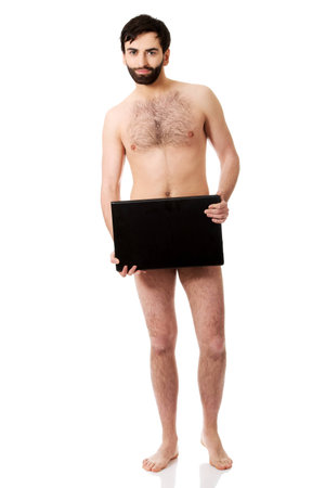 Young handsome shirtless man holding laptop.の写真素材