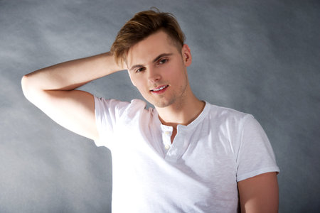 Young handsome man smiling to camera.