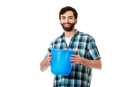 Young handsome man holding plastic blue bucket.の写真素材