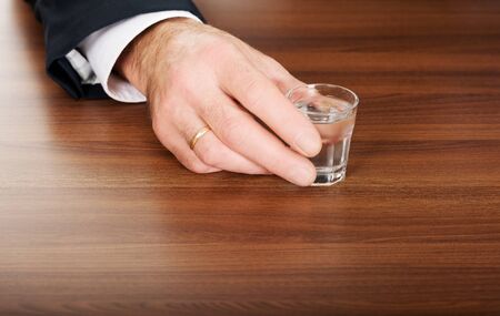 Businessmans hand with a glass of alcohol.の写真素材