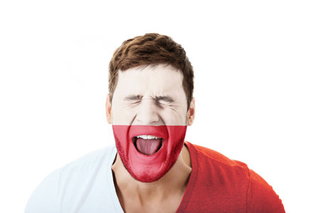 Screaming man with Poland flag painted on face.の写真素材