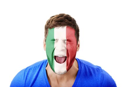 Screaming man with Italy flag painted on face.の写真素材