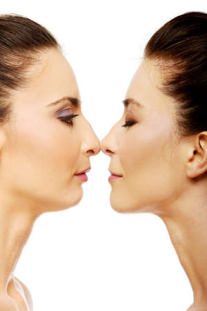 Two attractive sisters standing face to face.の写真素材